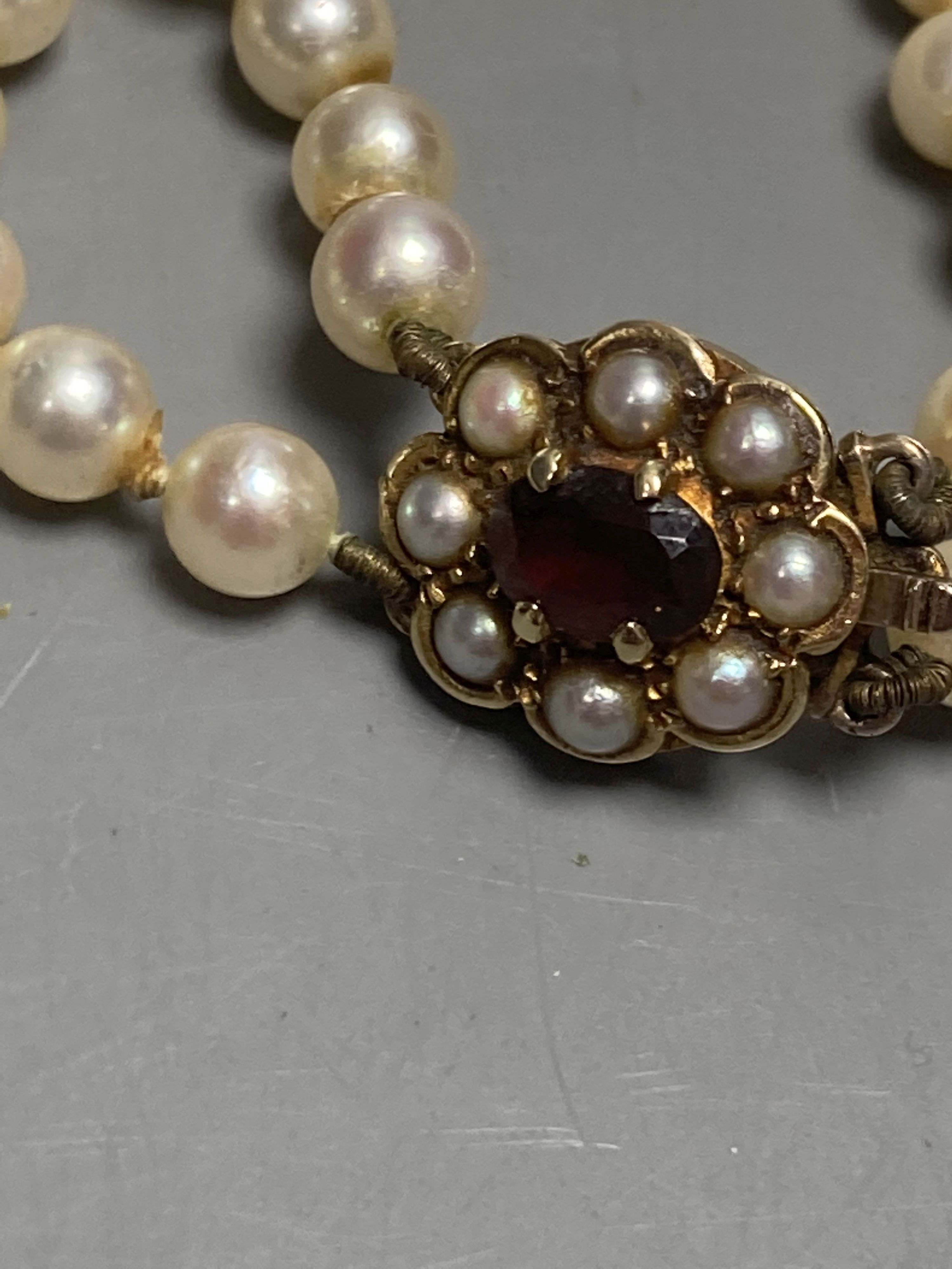 A double strand graduated cultured pearl necklace, with 9ct, garnet and cultured pearl cluster set clasp & 4 other items.